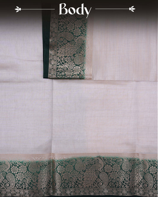 Cream colour Tussar silk saree Featuring Plain body, complemented by Contrast dark green colour gold zari peacock & mango motifs on border, paired with matching blouse piece.
