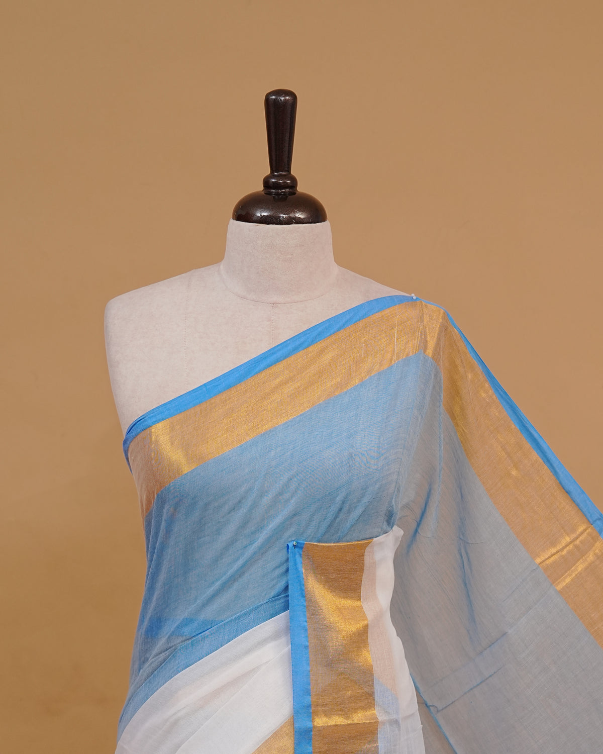 White Colour Mul Cotton Saree Featuring Plain body. With Contrast Gold and Blue Border, pallu comes With Blue Tassels