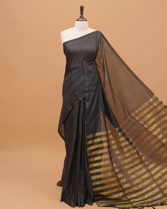 Black Colour Mul Cotton Saree Featuring Plain body. With out Border Golden Strips on pallu comes With Tassels