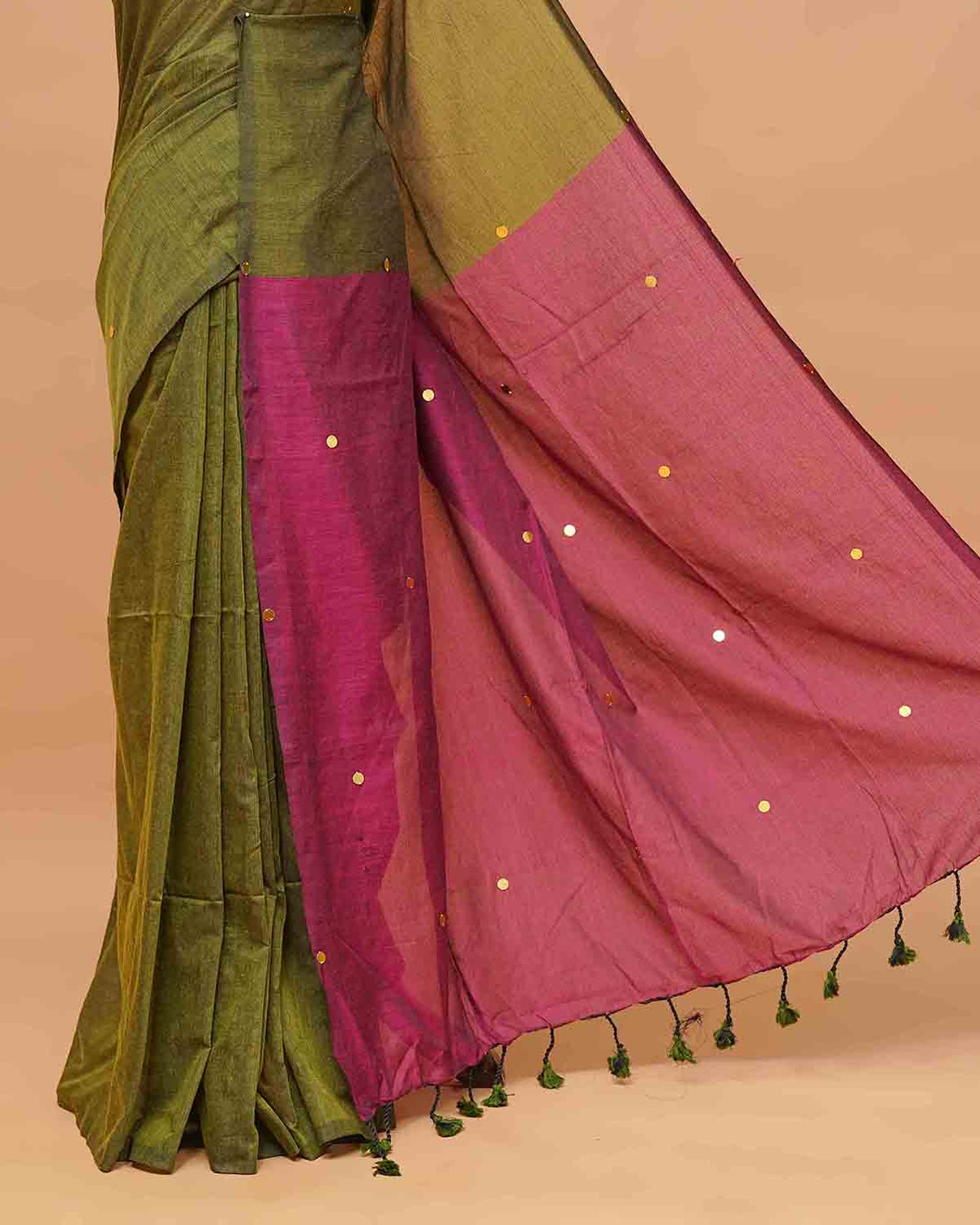 Olive and wine coloured half and half mul cotton saree featuring elegant sequin detailing on the body, finished with a beautiful pallu adorned with tassels.