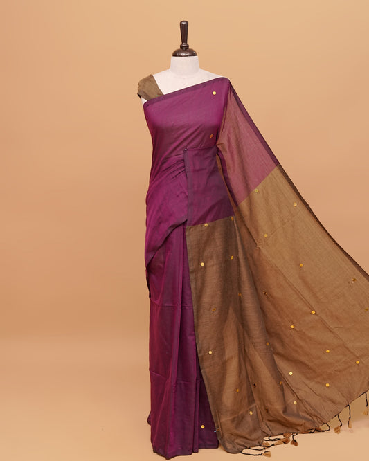 Wine and Kakhi Brown coloured half and half mul cotton saree featuring elegant sequin detailing on the body, finished with a beautiful pallu adorned with tassels.