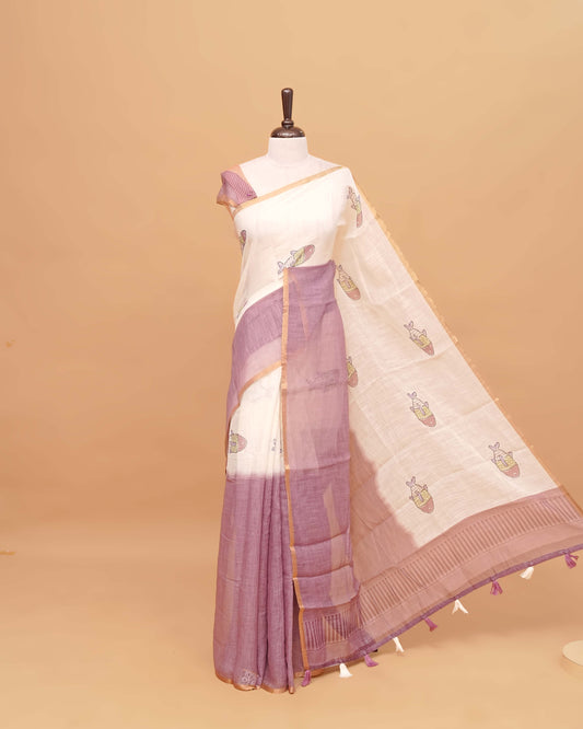 Off white and Mauve colour semi linen saree featuring adorable fish prints on the body, a delicate tissue border, and a pallu adorned with tassels, Comes with a matching blouse piece.