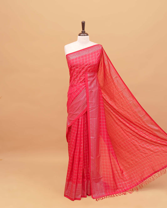 Reddish Pink colour semi silk saree featuring elegant foil checks on the body, complemented by a grand border and a beautiful pallu adorned with tassels.