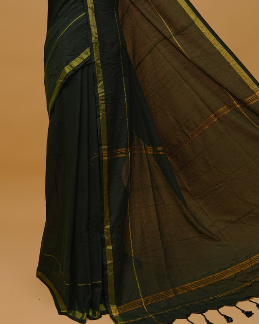 Dark Green Colour Mul Cotton Saree Featuring Plain body. Gold zari Border & Golden Strips on pallu comes With Tassels