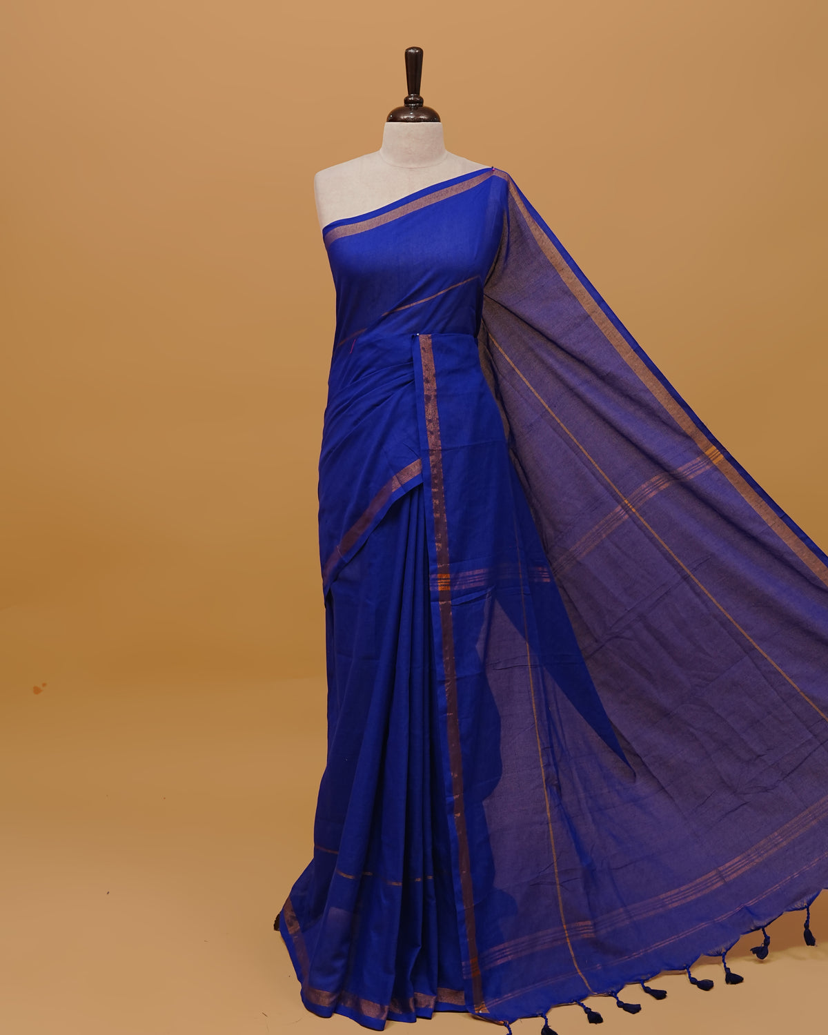 Blue Colour Mul Cotton Saree Featuring Plain body. Copper zari Border & Copper zari Strips on pallu comes With Tassels