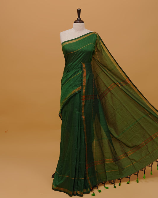 Bottle Green Colour Mul Cotton Saree Featuring Plain body. Copper zari Border & Copper zari Strips on pallu comes With Tassels