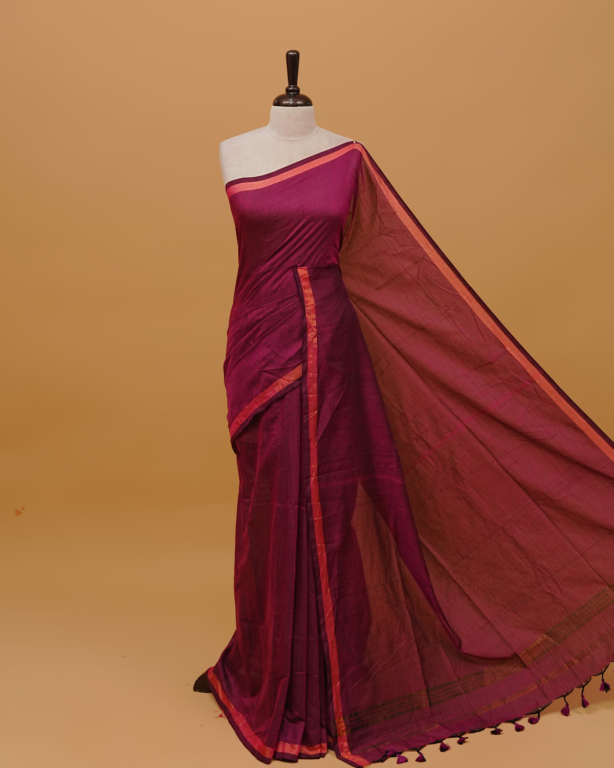 Magenta Colour Mul Cotton Saree Featuring Plain body. Gold zari Border & Golden Strips on pallu comes With Tassels