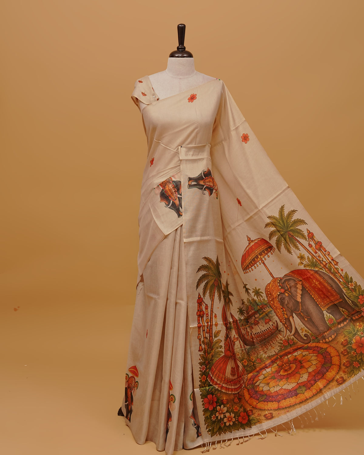 Cream colour Semi Tissue saree featuring Kerala Traditional Prints on the body, a Simple Border , and a pallu finished with tassels, paired with a matching blouse piece.