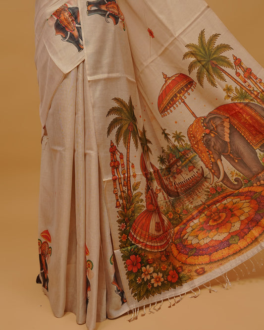 Cream colour Semi Tissue saree featuring Kerala Traditional Prints on the body, a Simple Border , and a pallu finished with tassels, paired with a matching blouse piece.