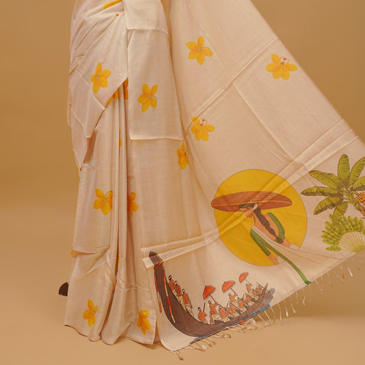 Cream colour semi tissue saree featuring yellow floral prints on the body, without border &  Traditional festival printed pallu finished with tassels. Paired with a matching blouse piece.