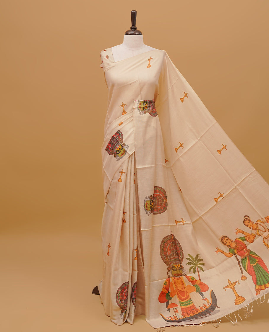 Cream colour semi tissue saree featuring Kerala traditional prints on the body, without  border & pallu finished with tassels. Paired with a matching blouse piece.