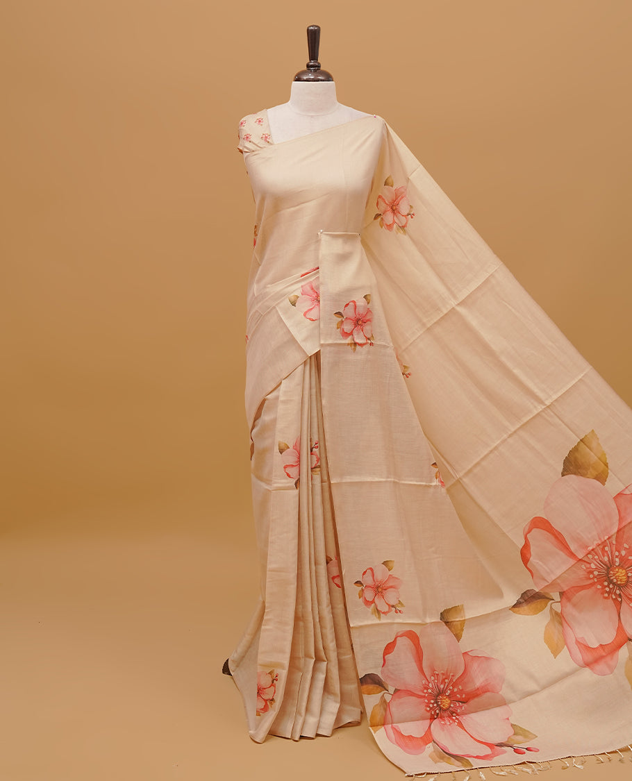 Cream colour semi tissue saree featuring floral prints on body, borderless design & pallu finished with tassels. Paired with a matching blouse piece.