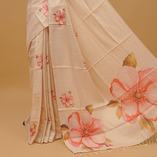 Cream colour semi tissue saree featuring floral prints on body, borderless design & pallu finished with tassels. Paired with a matching blouse piece.