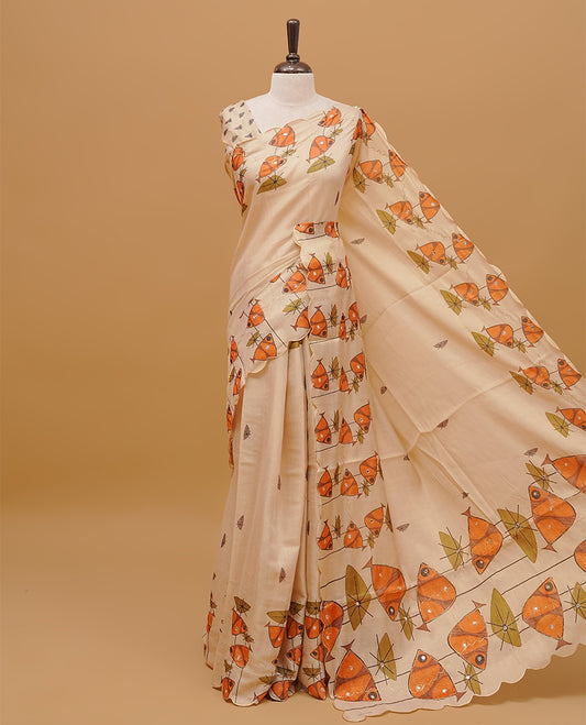Cream colour  semi tissue saree featuring fish prints with Mirror Work on the body, with scallop border & pallu finished with tassels. Paired with a matching blouse piece.