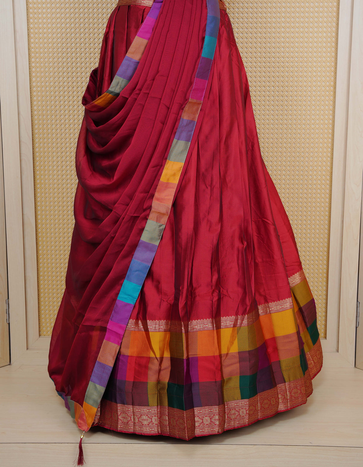 Maroon colour Semi Silk Semi stitched dhavani set featuring a Plain body with a matching Multi colour with gold zari bordered skirt & blouse piece and dupatta.