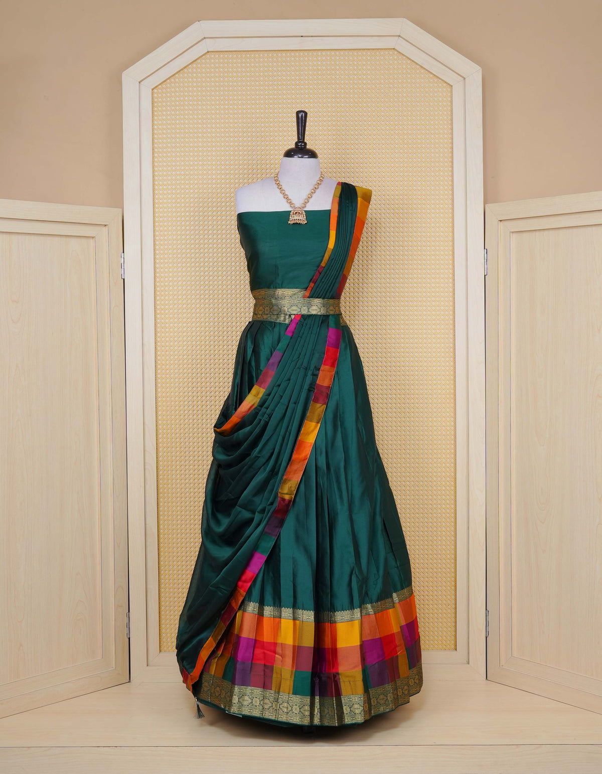 Bottle green colour Semi Silk Semi stitched dhavani set featuring a Plain body with a matching Multi colour with gold zari bordered skirt & blouse piece and dupatta.