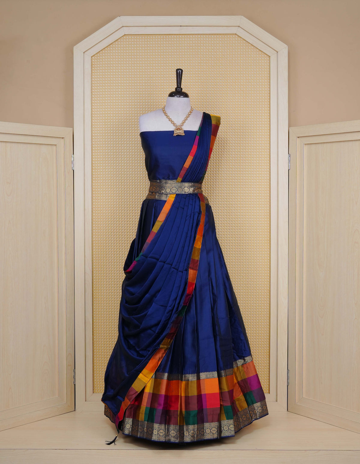 Navy blue colour Semi Silk Semi stitched dhavani set featuring a Plain body with a matching Multi colour with gold zari bordered skirt & blouse piece and dupatta.