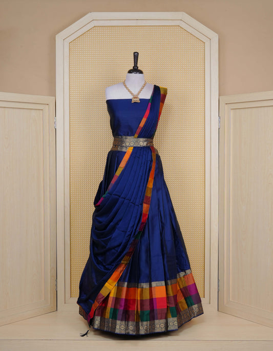 Navy blue colour Semi Silk Semi stitched dhavani set featuring a Plain body with a matching Multi colour with gold zari bordered skirt & blouse piece and dupatta.