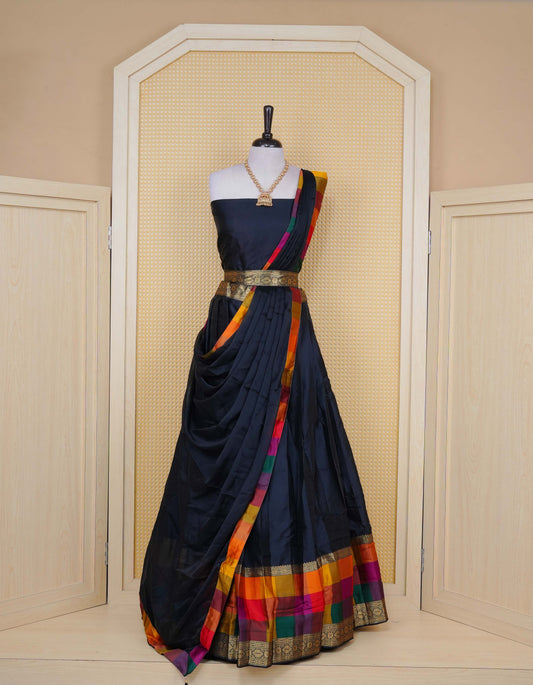 Black colour Semi Silk Semi stitched dhavani set featuring a Plain body with a matching Multi colour with gold zari bordered skirt & blouse piece and dupatta.