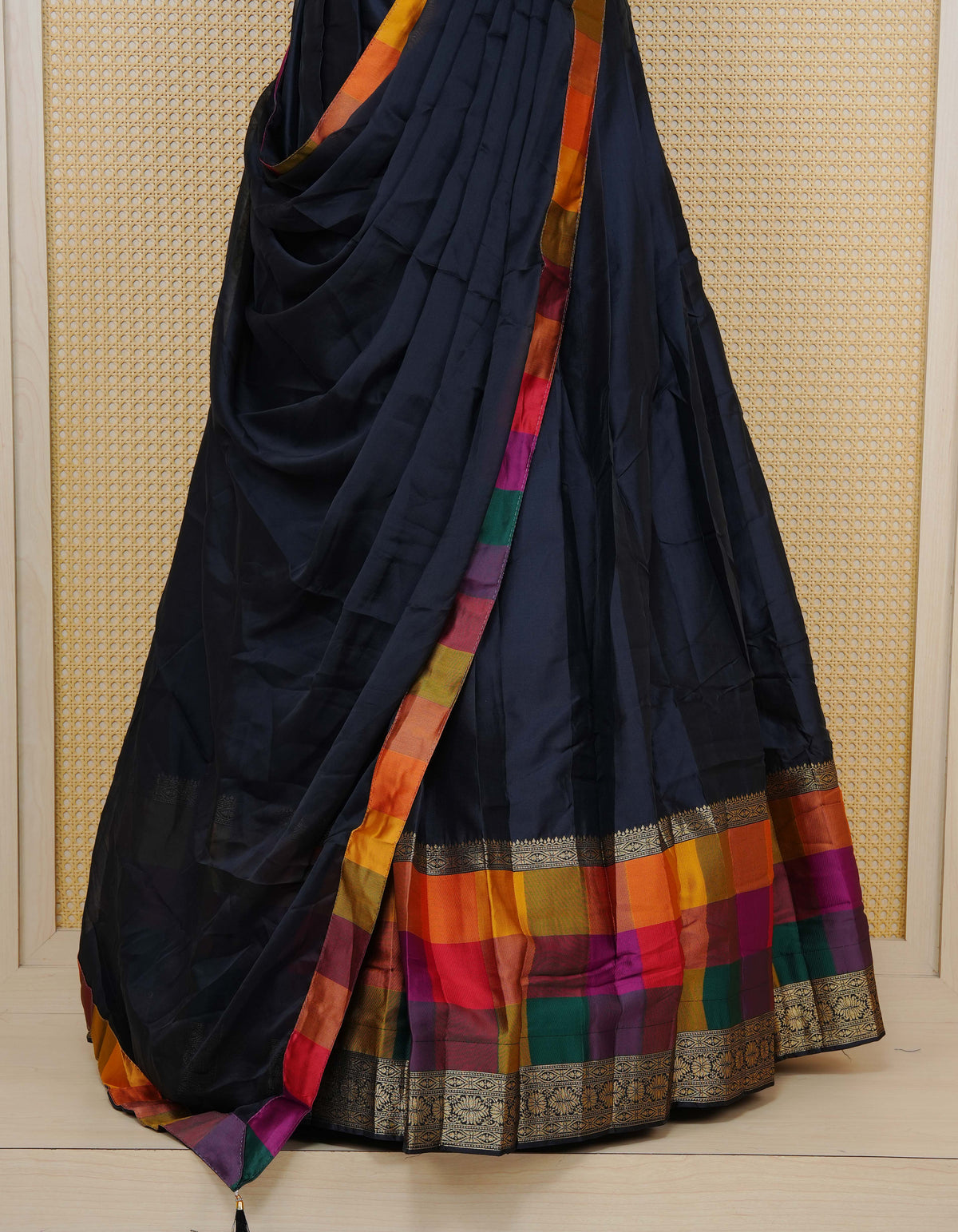 Black colour Semi Silk Semi stitched dhavani set featuring a Plain body with a matching Multi colour with gold zari bordered skirt & blouse piece and dupatta.