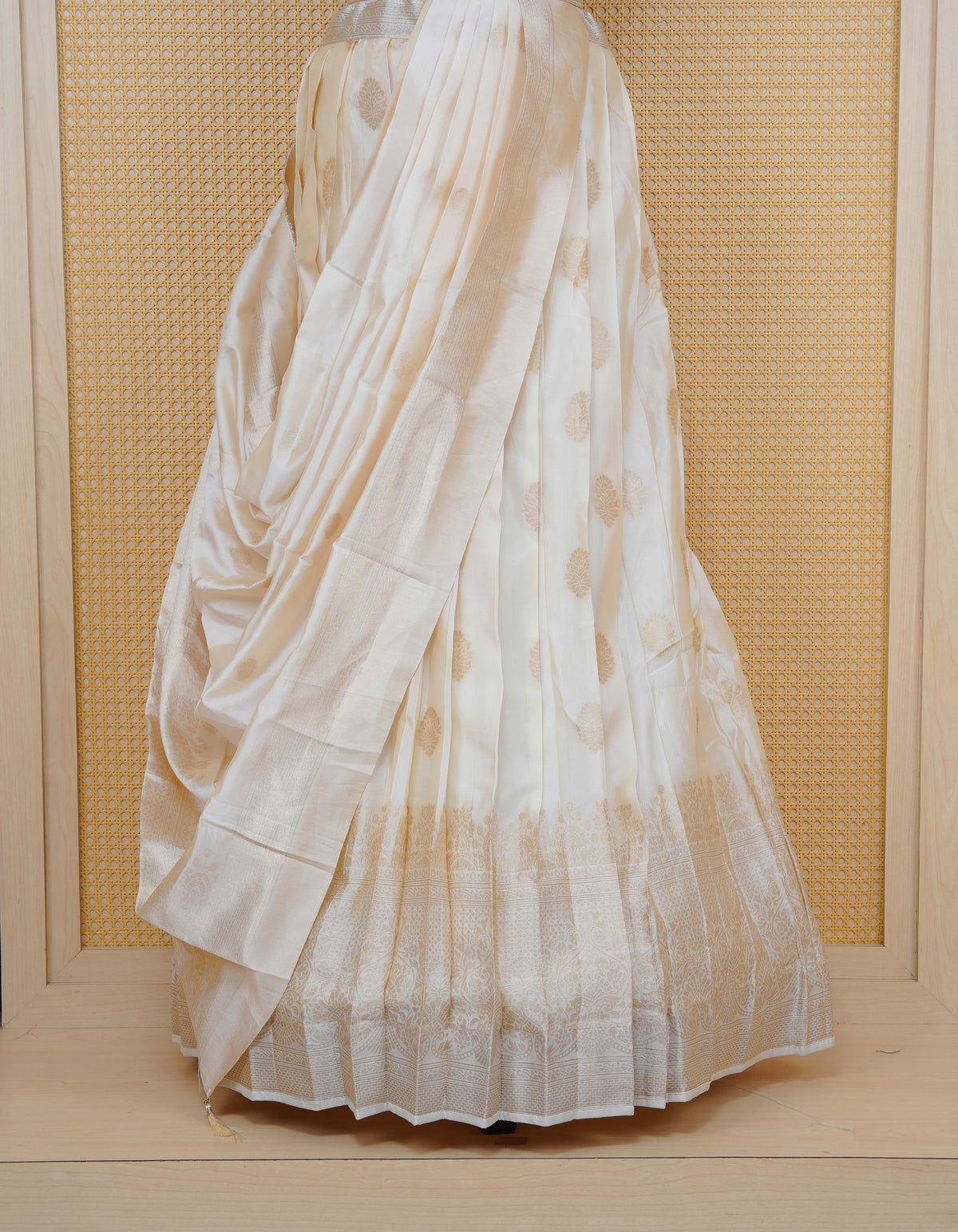 Cream colour Semi Silk Semi stitched dhavani set featuring Gold zari motifs on body ,contrast self colour with gold zari bordered skirt, paired with matching blouse piece & dupatta.