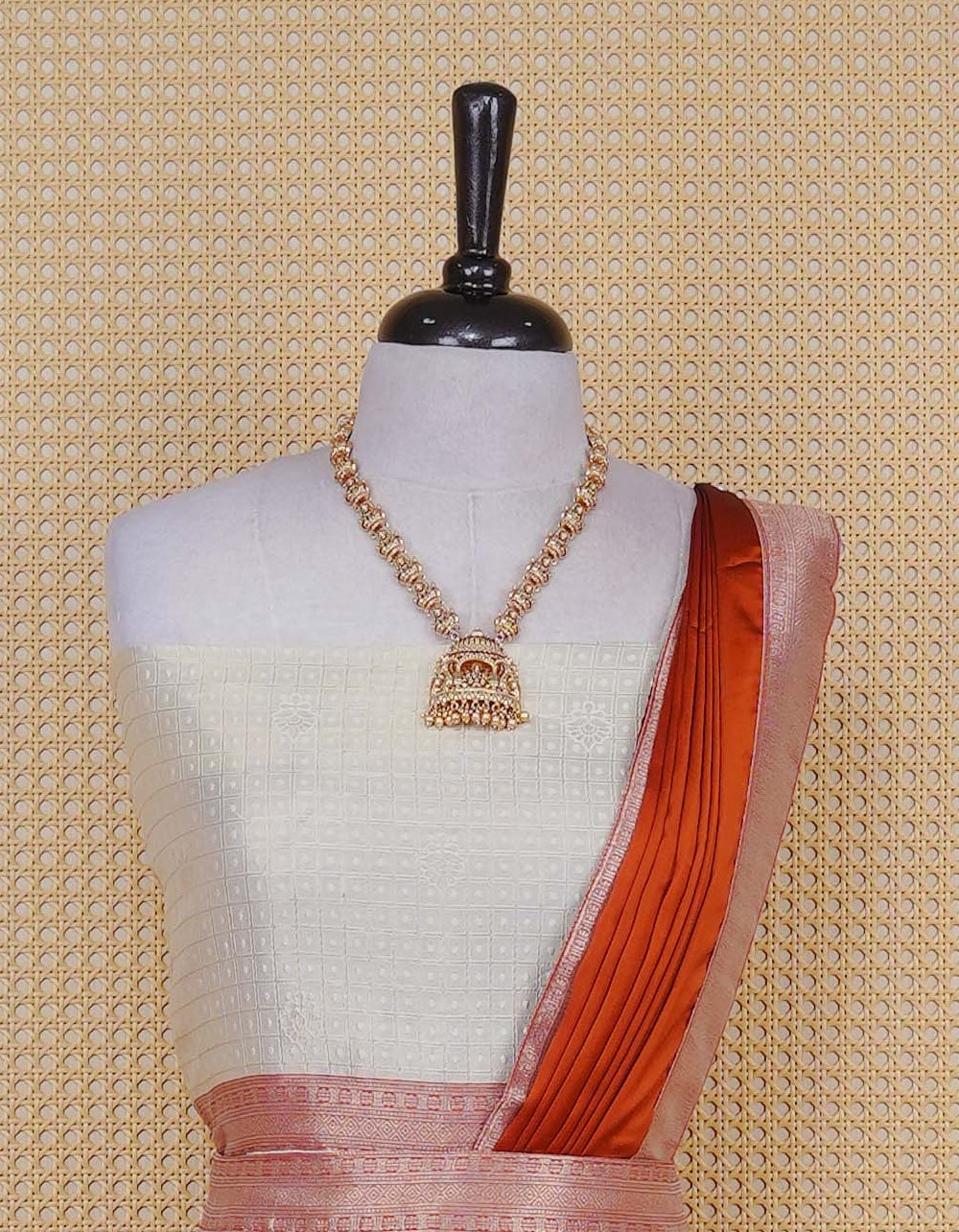 Cream colour Semi Silk Semi stitched dhavani set featuring Gold zari check pattern with motifs on body ,contrast Peach colour with gold zari bordered skirt, paired with matching blouse piece & dupatta.