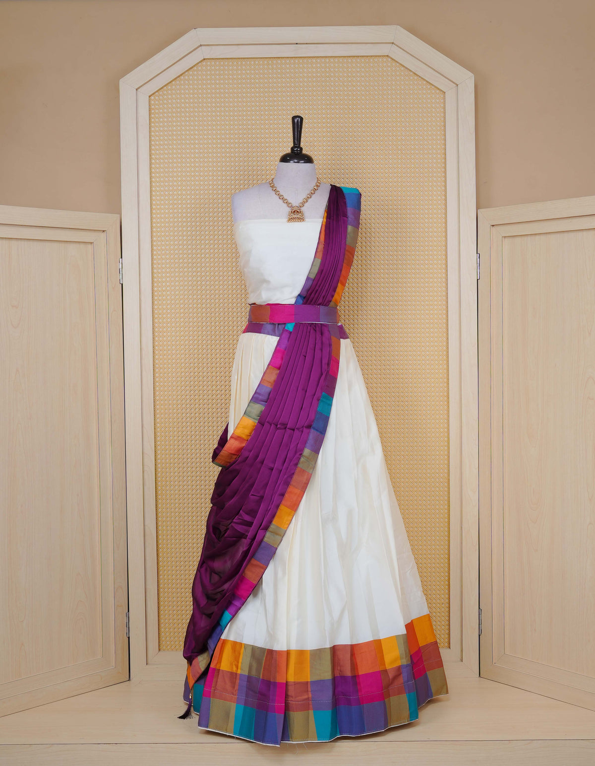 Cream colour  Semi Silk Semi stitched dhavani set featuring a Plain body with a matching Multi colour with gold zari bordered skirt & blouse piece and dupatta.