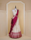 Cream colour Semi Silk Semi stitched dhavani set featuring Gold zari check pattern with motifs on body ,contrast Red colour with gold zari bordered skirt, paired with matching blouse piece & dupatta.