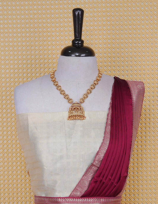 Cream colour Semi Silk Semi stitched dhavani set featuring Gold zari check pattern with motifs on body ,contrast Red colour with gold zari bordered skirt, paired with matching blouse piece & dupatta.