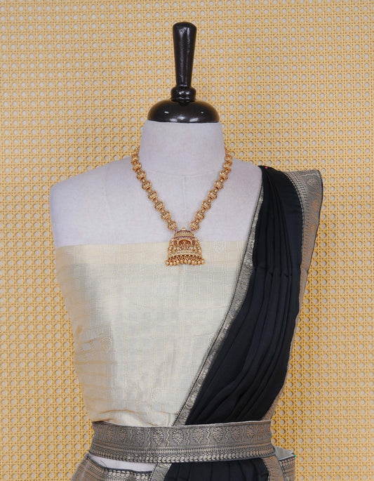 Cream colour Semi Silk Semi stitched dhavani set featuring Gold zari check pattern with motifs on body ,contrast Black colour with gold zari bordered skirt, paired with matching blouse piece & dupatta
