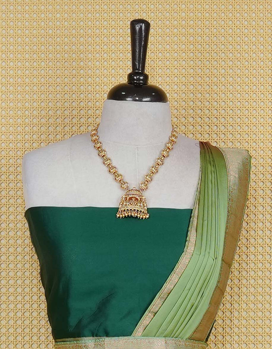 Bottle green colour Semi Silk  Semi stitched dhavani set featuring a Plain body with a matching contrast Pista Green colour with copper zari bordered skirt & blouse piece and dupatta.