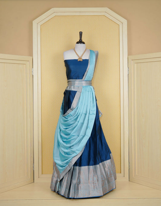 Navy Blue colour Semi Silk Semi stitched dhavani set featuring a Plain body with a matching contrast Sky blue colour with copper zari bordered skirt & blouse piece and dupatta.