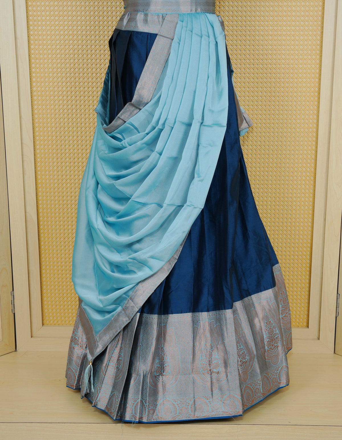 Navy Blue colour Semi Silk Semi stitched dhavani set featuring a Plain body with a matching contrast Sky blue colour with copper zari bordered skirt & blouse piece and dupatta.