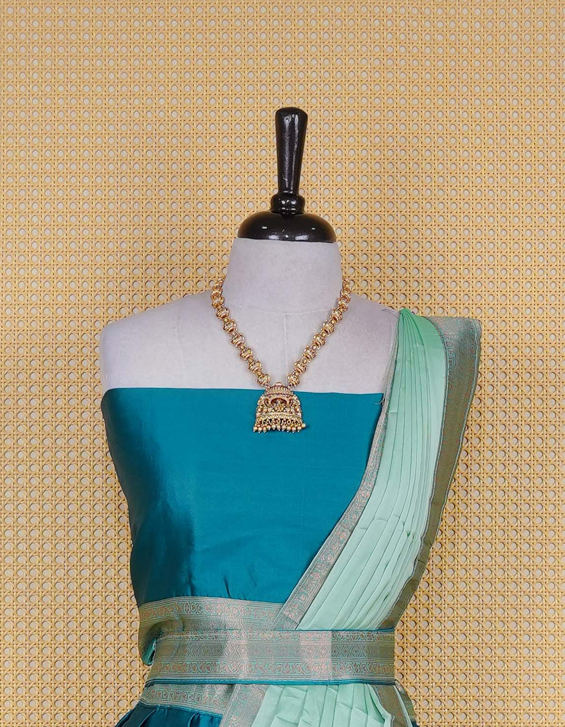Peacock Green colour semi silk semi stitched dhavani set featuring a Plain body with a matching copper zari bordered skirt & blouse piece and dupatta.