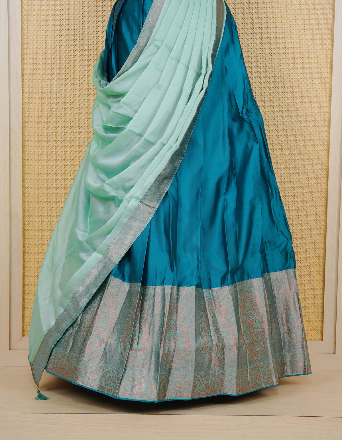 Peacock Green colour semi silk semi stitched dhavani set featuring a Plain body with a matching copper zari bordered skirt & blouse piece and dupatta.