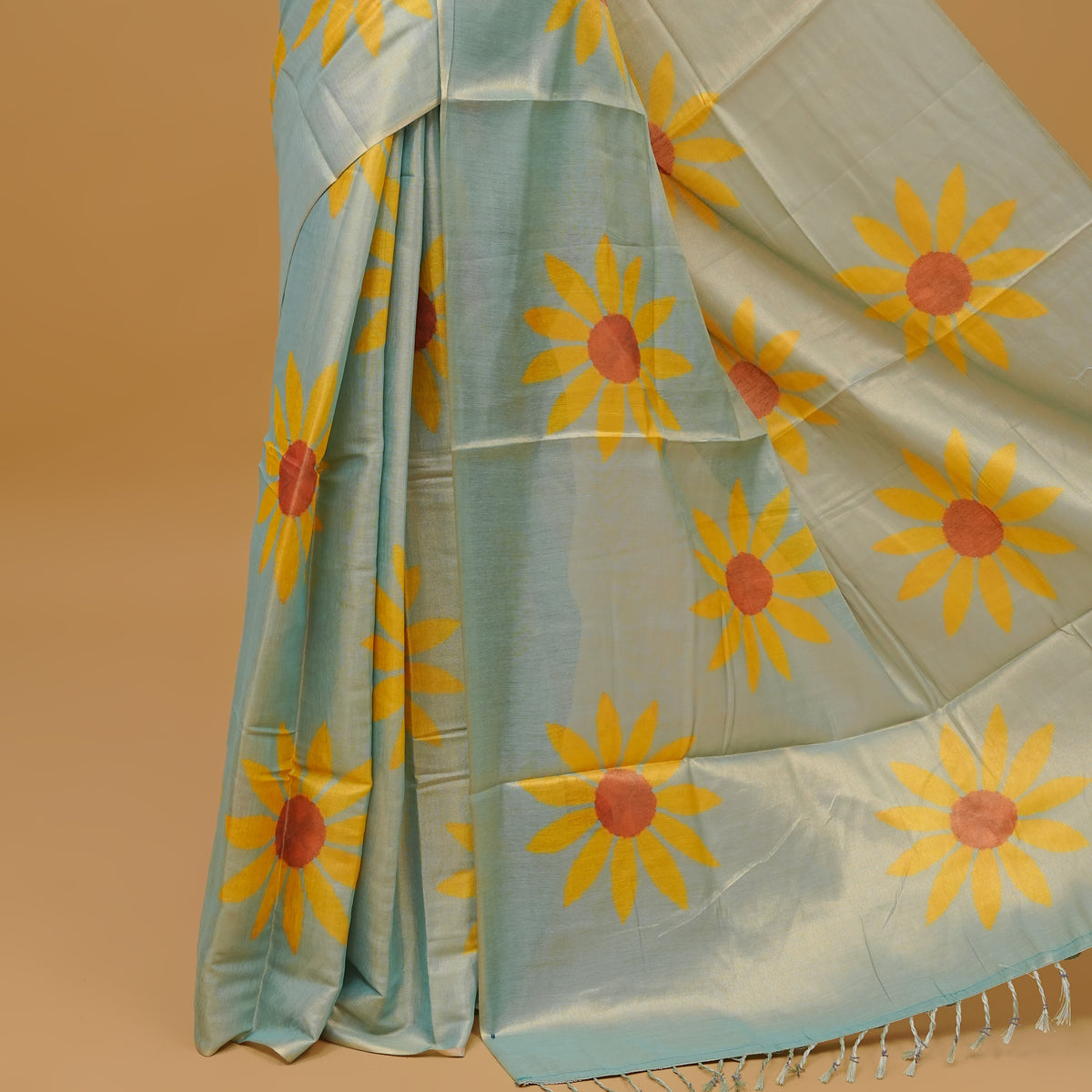 Mint colour Semi Tissue saree featuring a yellow floral prints on body, Without border & pallu finished with tassels. Paired with a matching blouse piece.