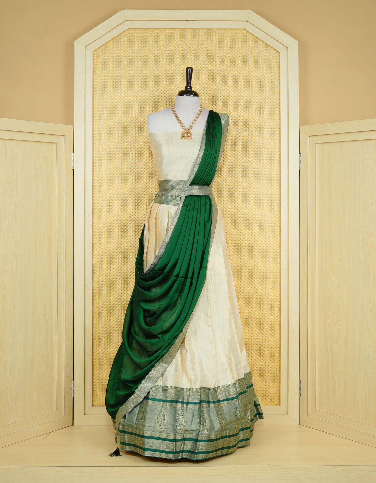 Cream colour tissue semi stitched dhavani set featuring gold zari Check patterns with motifs on the body and a matching Contrast Green colour with  gold zari bordered skirt & blouse piece and dupatta.