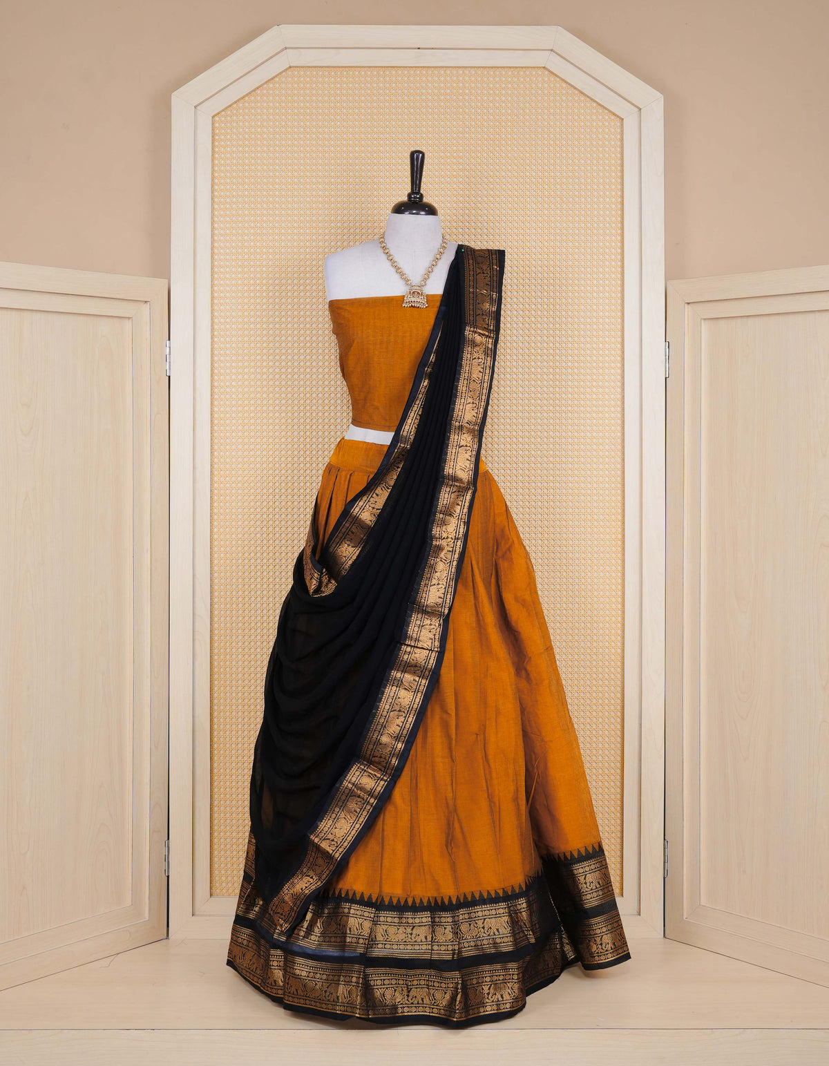 Mustard colour Chettinad Semi Stitched dhavani set Featuring contrast Black with Gold zari border on skirt, Contrast Blouse piece & matching dupatta.