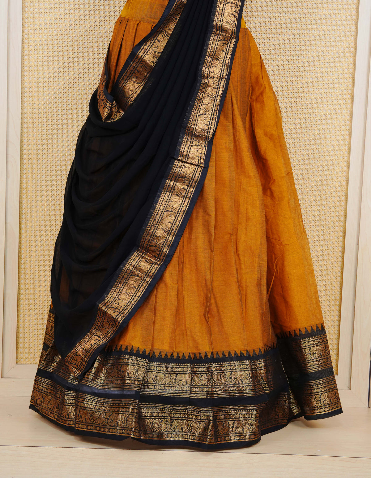 Mustard colour Chettinad Semi Stitched dhavani set Featuring contrast Black with Gold zari border on skirt, Contrast Blouse piece & matching dupatta.