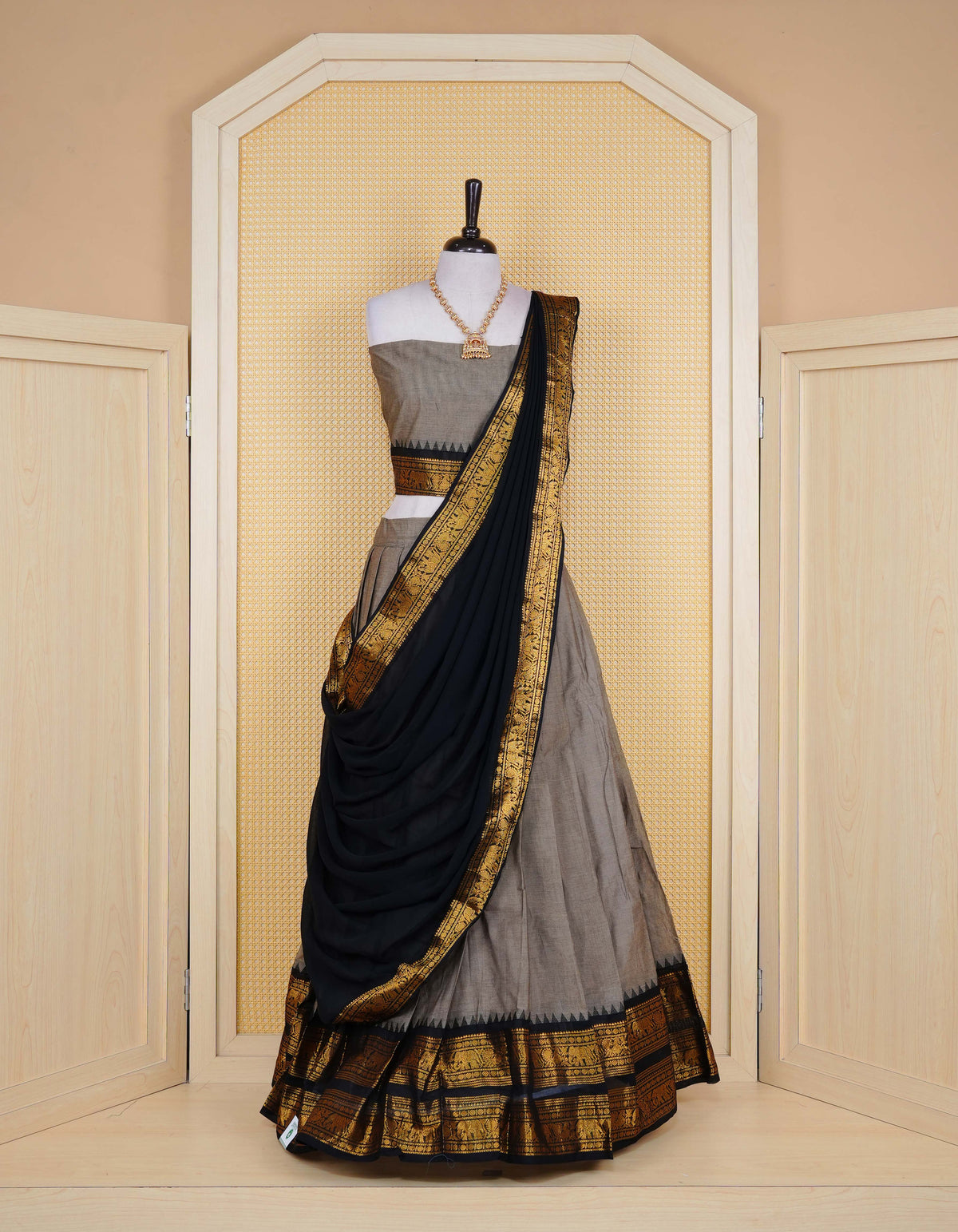 Grey colour Chettinad Semi Stitched dhavani set Featuring contrast Black with Gold zari border on skirt, Contrast Blouse piece & matching dupatta.