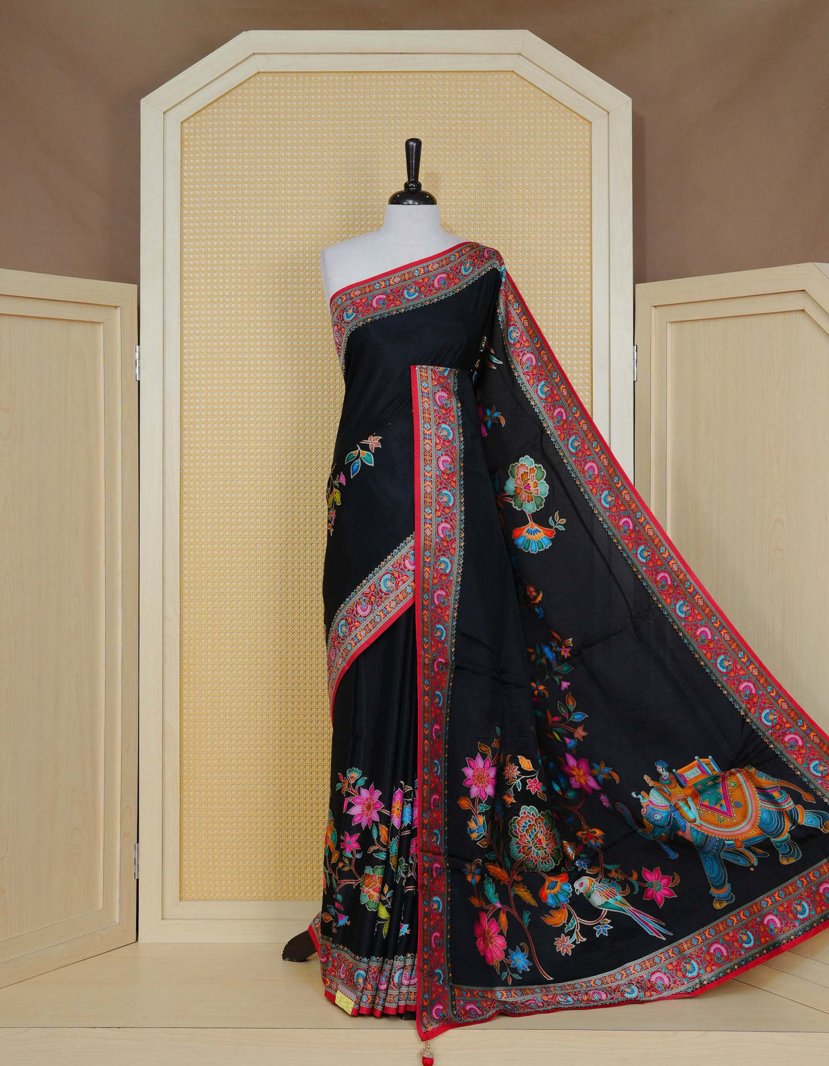 Black Colour Pashmina Saree featuring multi colour patterns on body, complemented by Contrast red colour floral motifs zari patterns on border and Pallu, comes with matching blouse piece