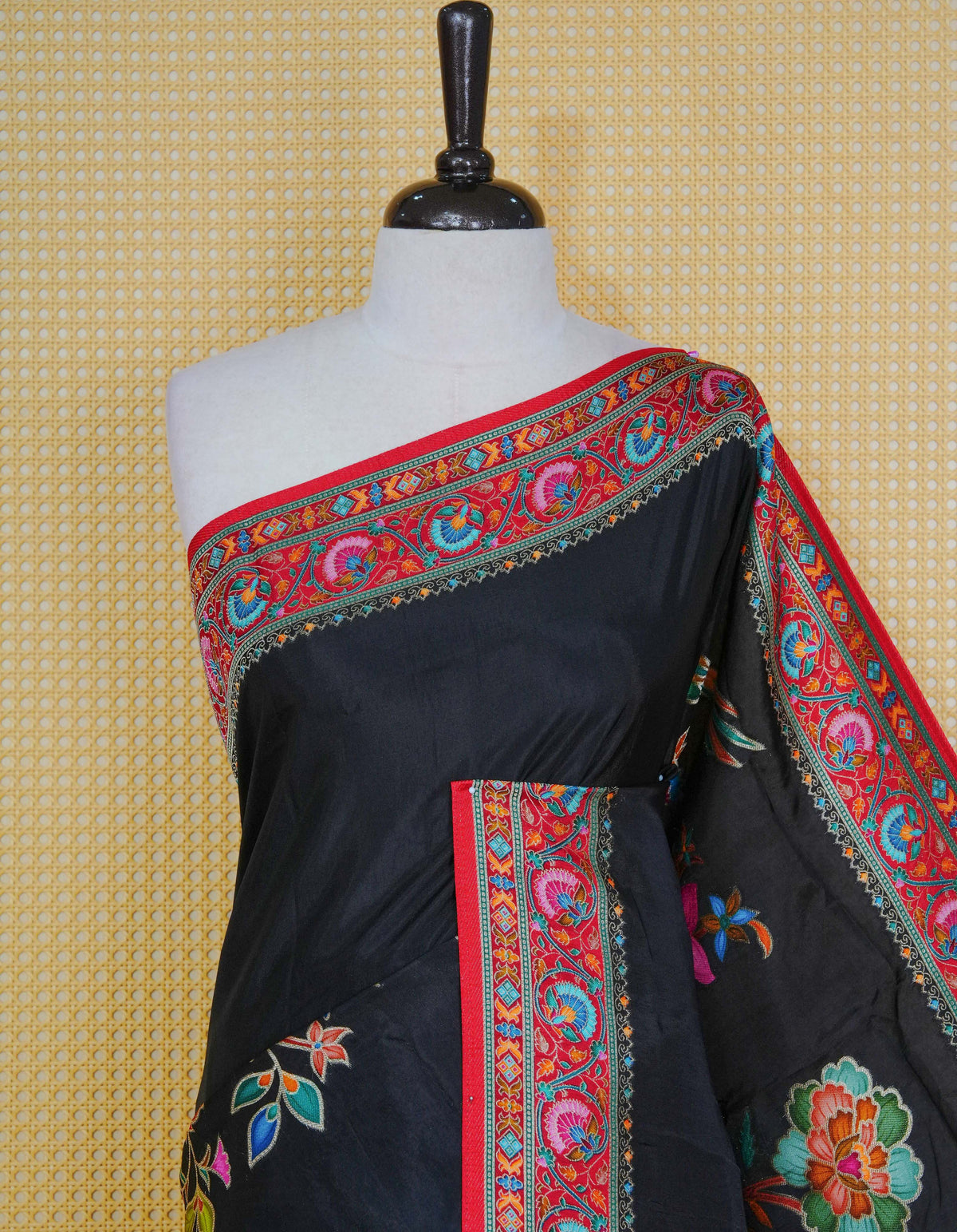 Black Colour Pashmina Saree featuring multi colour patterns on body, complemented by Contrast red colour floral motifs zari patterns on border and Pallu, comes with matching blouse piece