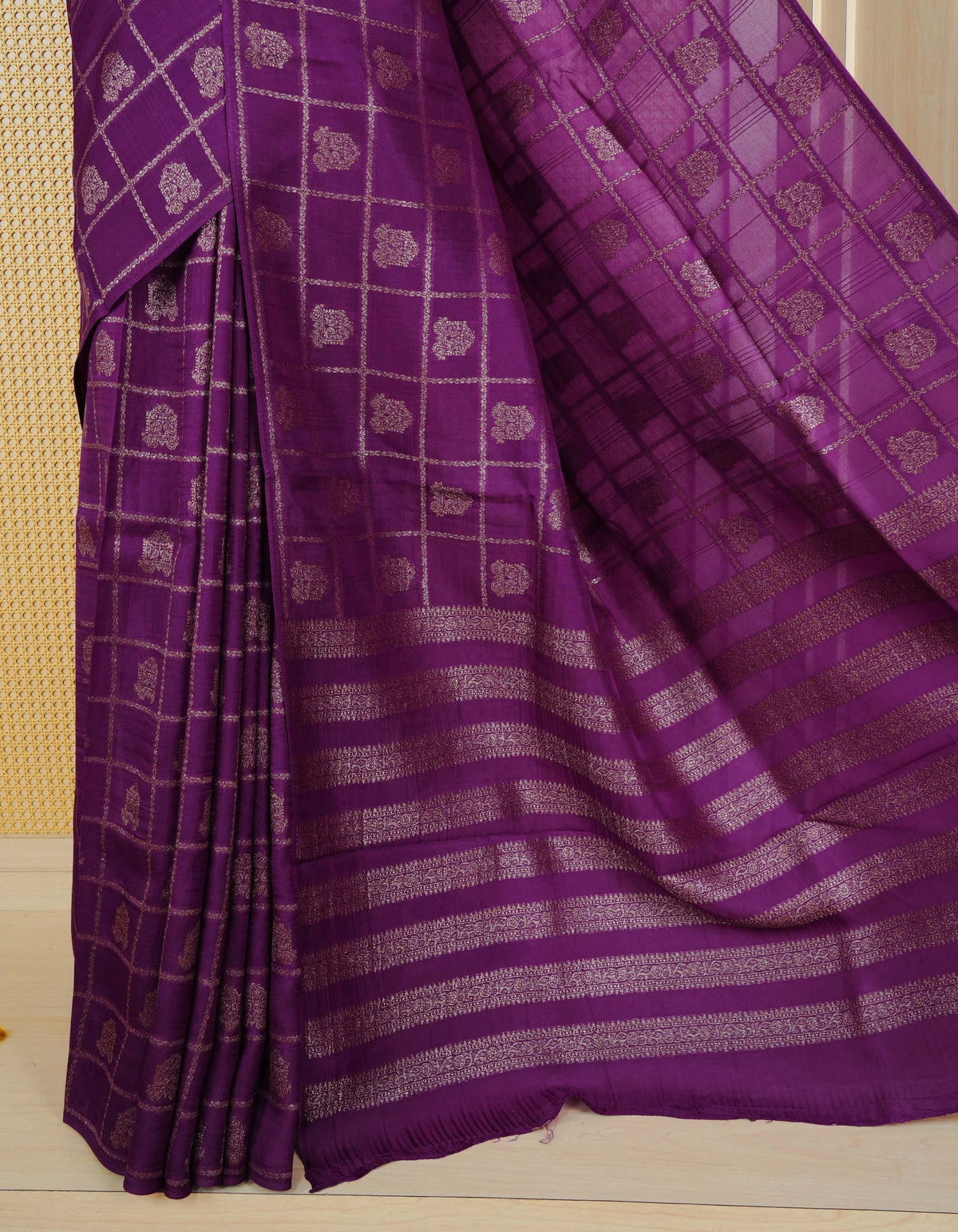 Purple colour semi banaras tussar georgette saree featuring gold zari check with motifs on body, no specific border and paired with matching blouse piece.