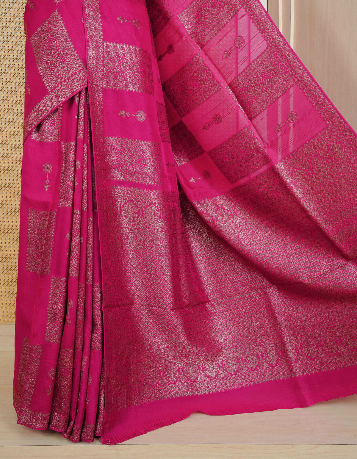 Pink colour semi banaras tussar georgette saree featuring gold zari box pattern with motifs on body, finished with gold zari fancy border and paired with matching blouse piece.