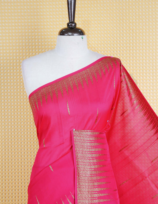 Pink colour semi banaras tussar georgette saree featuring gold zari pattern on body, finished with gold zari temple border and paired with matching blouse piece.
