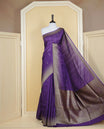 Rich purple colour semi banaras tussar georgette saree featuring gold zari pattern on body, finished with gold zari temple border and paired with matching blouse piece.