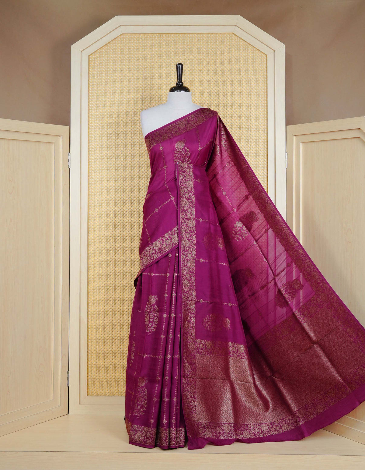 Purple colour semi banaras tussar georgette saree featuring gold zari floral pattern on body, finished with gold zari floral motifs on border and paired with matching blouse piece.
