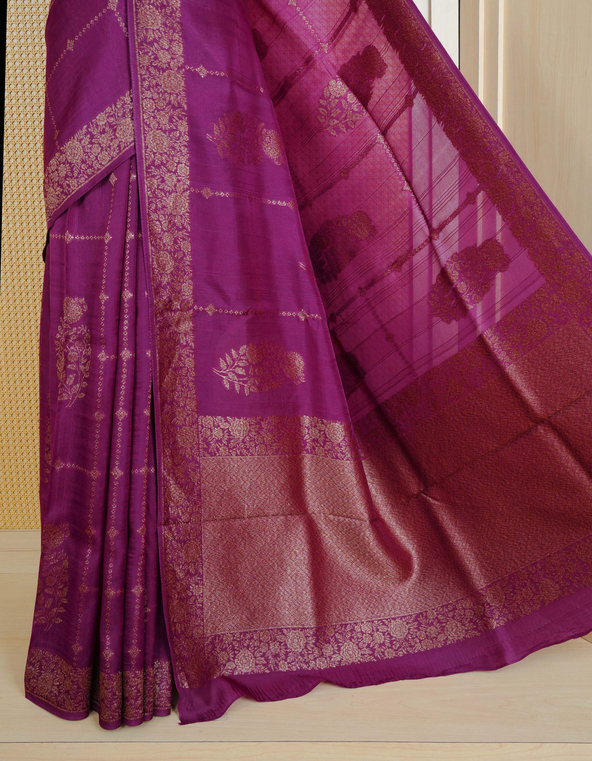 Purple colour semi banaras tussar georgette saree featuring gold zari floral pattern on body, finished with gold zari floral motifs on border and paired with matching blouse piece.