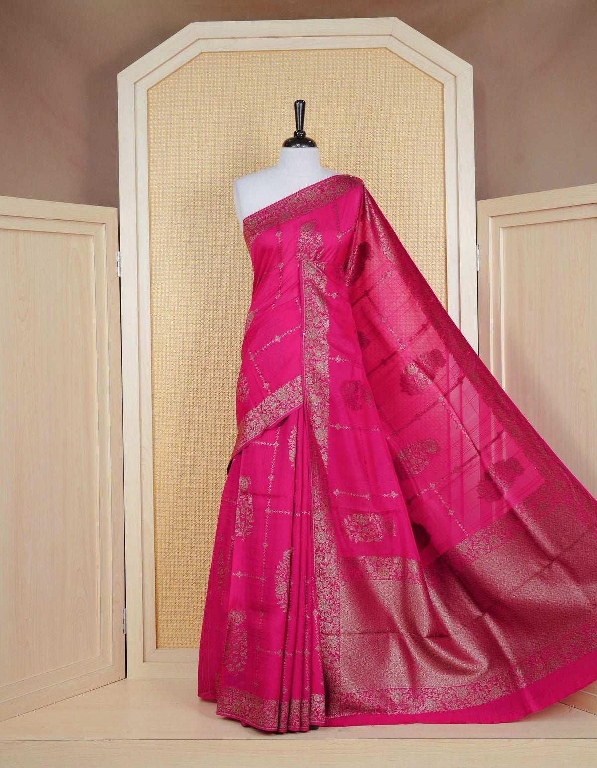 Pink colour semi banaras tussar georgette saree featuring gold zari floral pattern on body, finished with gold zari floral motifs on border and paired with matching blouse piece.