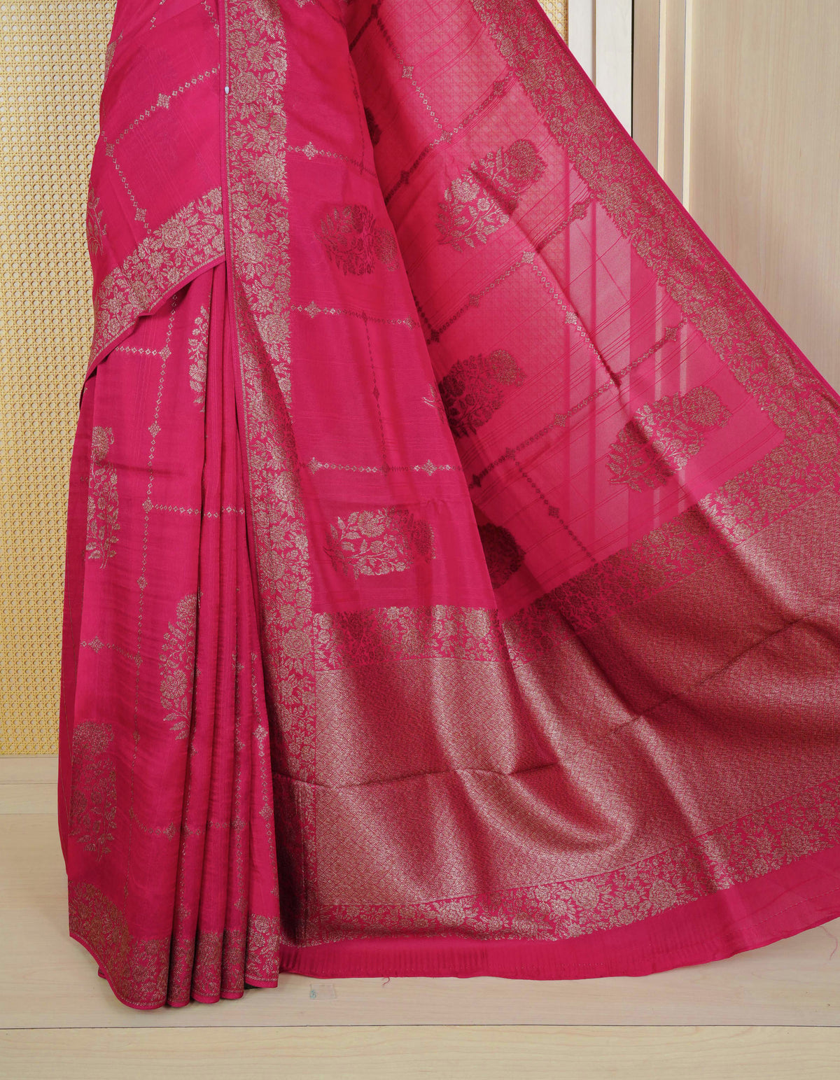 Pink colour semi banaras tussar georgette saree featuring gold zari floral pattern on body, finished with gold zari floral motifs on border and paired with matching blouse piece.
